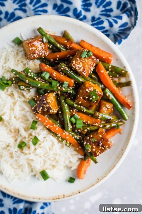 Sesame ginger tempeh stir fry served over white rice