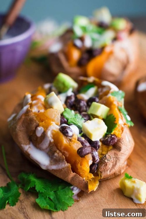 Sweet potato stuffed with black beans and avocado, garnished with cilantro