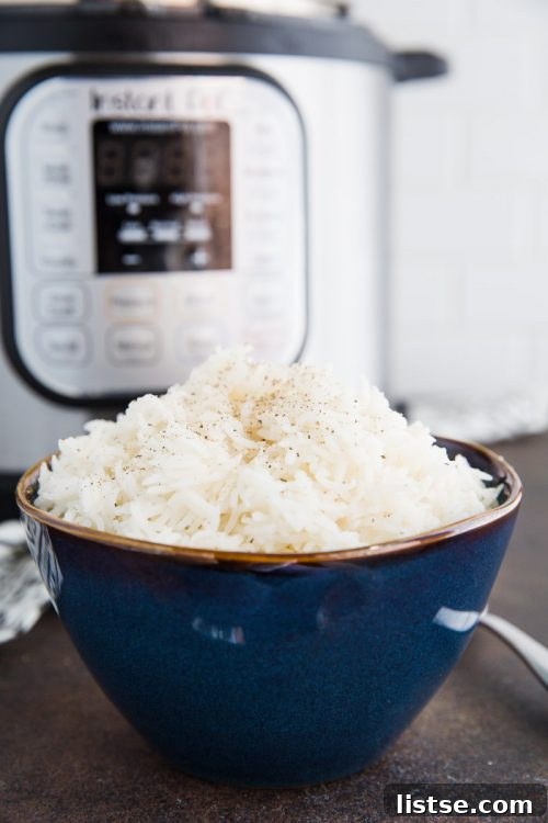 White basmati rice in a bowl in front of a pressure cooker