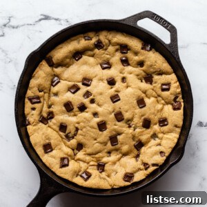 A beautifully baked vegan skillet cookie in a cast iron pan, ready for serving.