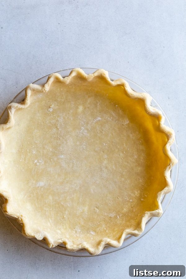 Close-up of flaky vegan pie dough being rolled out