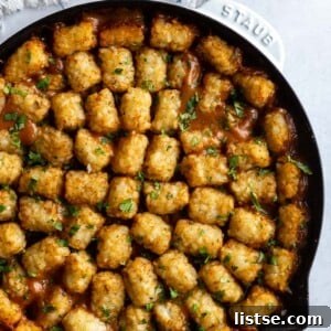 A serving of Vegan Tater Tot Casserole in a bowl, showing the crispy tater tots and creamy filling.