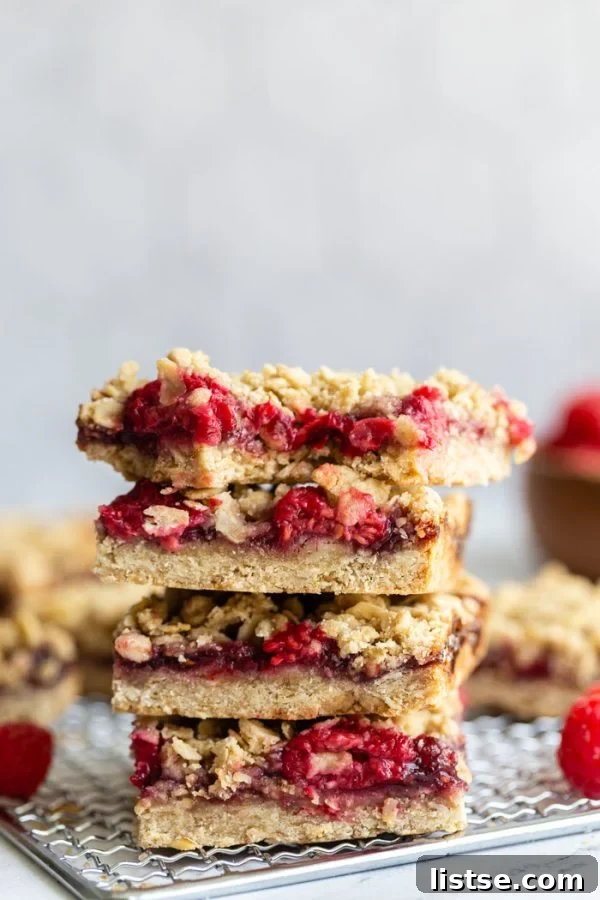 Delicious vegan raspberry crumble bars with a thick fruit filling and a golden crumb topping.
