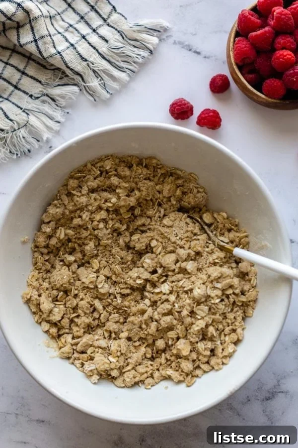 A close-up shot of a single vegan raspberry crumble bar, perfectly baked and ready to eat.