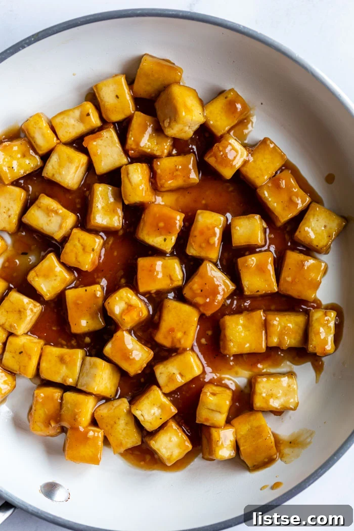 top down shot of sesame tofu cubes in a white skillet