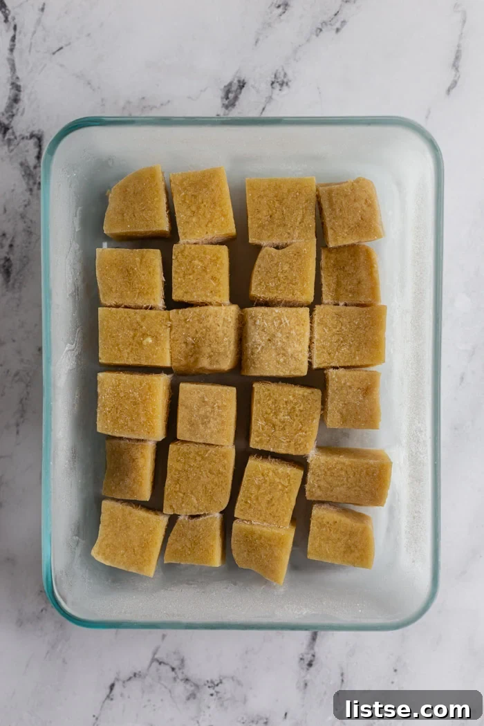 Golden Tofu Satay with Velvety Peanut Sauce 5 Two blocks of tofu placed in airtight containers, ready for freezing.