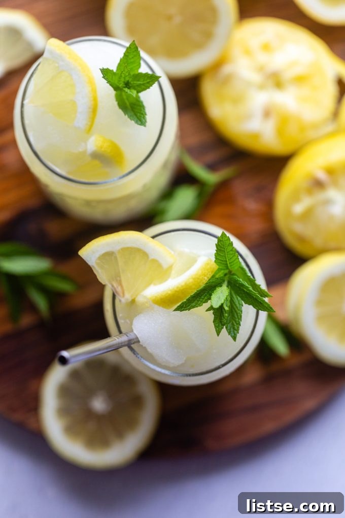 Close-up of a Boozy Frozen Lemonade with a straw, showing its smooth, icy texture.