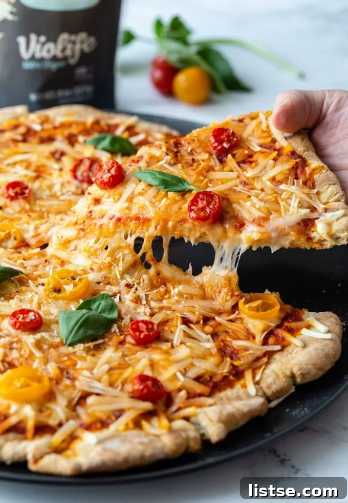 Smoky Plant-Based Grilled Pizza 2 A vibrant, cheesy vegan grilled pizza with fresh toppings, ready to be sliced.