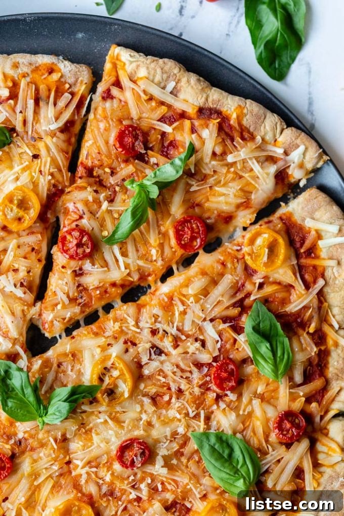 Smoky Plant-Based Grilled Pizza 4 Vegan pizza on a grill, with melted Violife mozzarella and various toppings.
