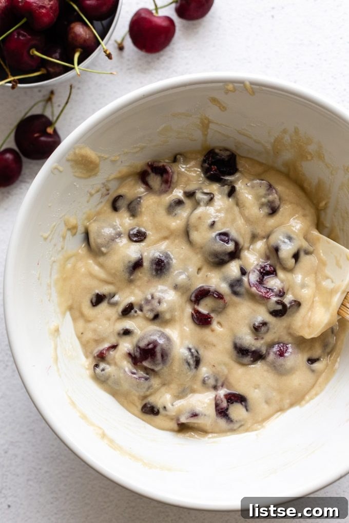 Freshly baked chocolate cherry coffee cake cooling on a wire rack, steam gently rising, highlighting the golden-brown crumble and fruit peeking through.