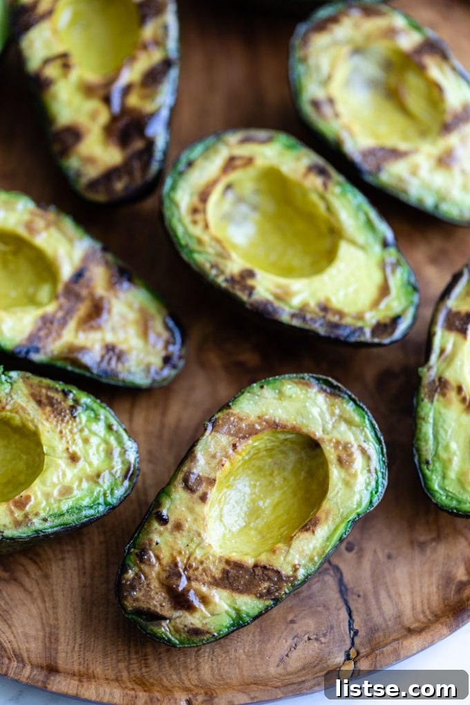 Sliced grilled avocados arranged beautifully, showcasing their creamy texture and smoky edges.