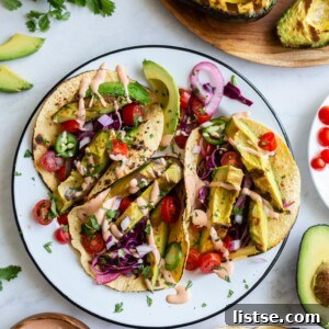 Beautifully arranged Grilled Avocado Tacos with toppings.
