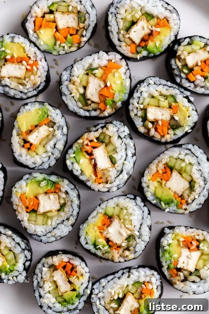 top down shot of a plate of tofu sushi filled with tofu, carrots, avocado, and cucumber
