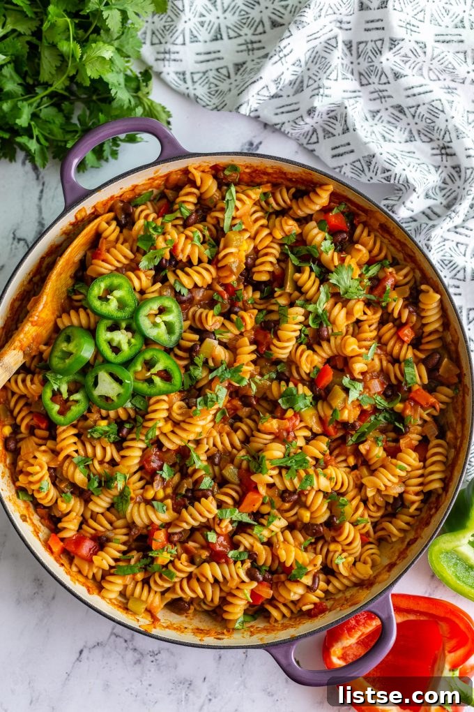 Delicious one-pot vegan taco pasta in a large skillet, garnished with fresh cilantro.