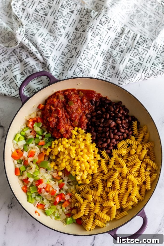 Ingredients for vegan taco pasta laid out, including McCormick seasoning, pasta, and vegetables.