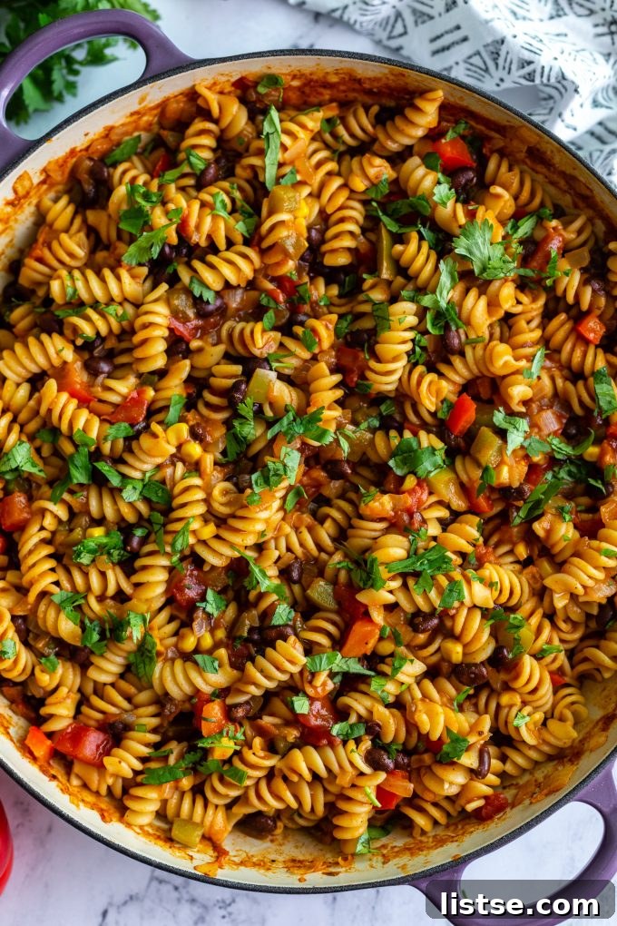 A close-up shot of creamy vegan taco pasta simmering in a pot.
