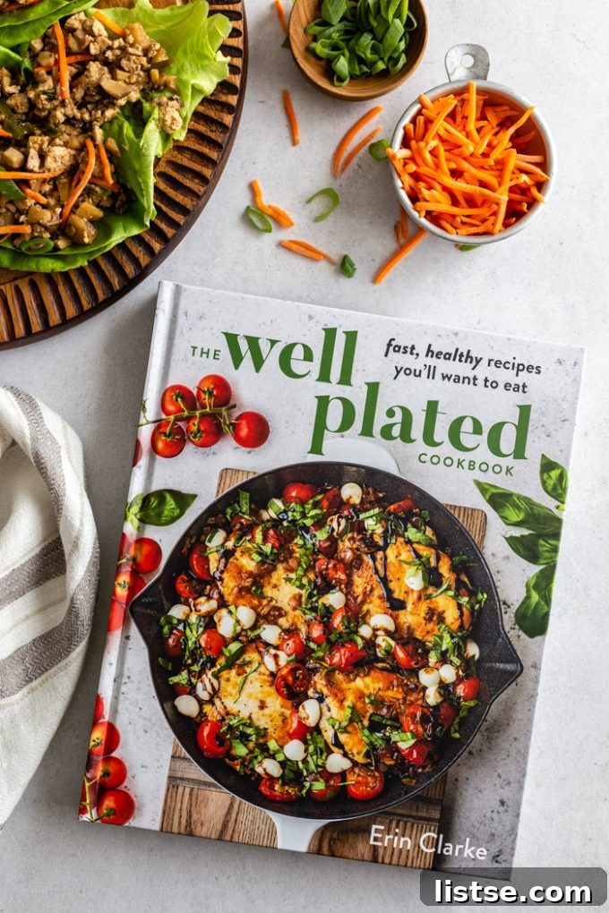 picture of the Well Plated Cookbook with carrots, lettuce wraps, and green onion in the corner
