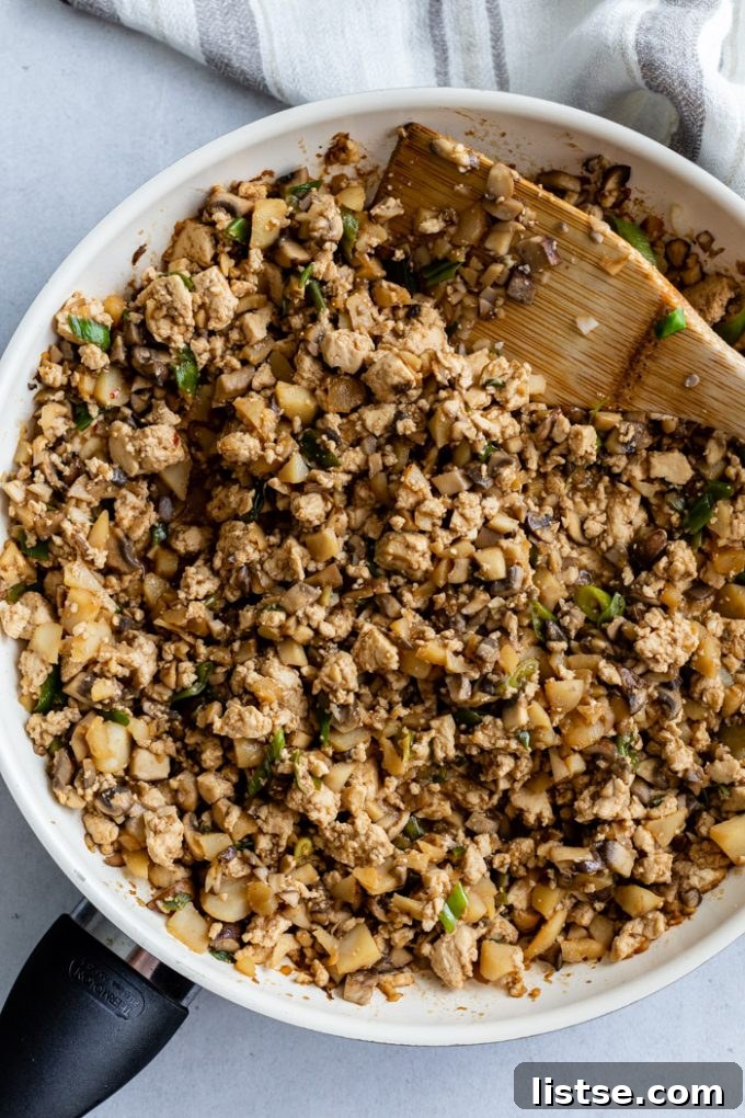 top down shot of tofu lettuce wrap mixture in a white skillet
