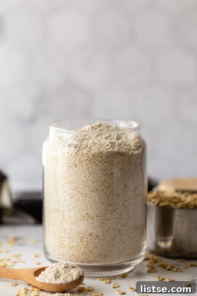 glass container filled with oat flour and fresh oats in the background
