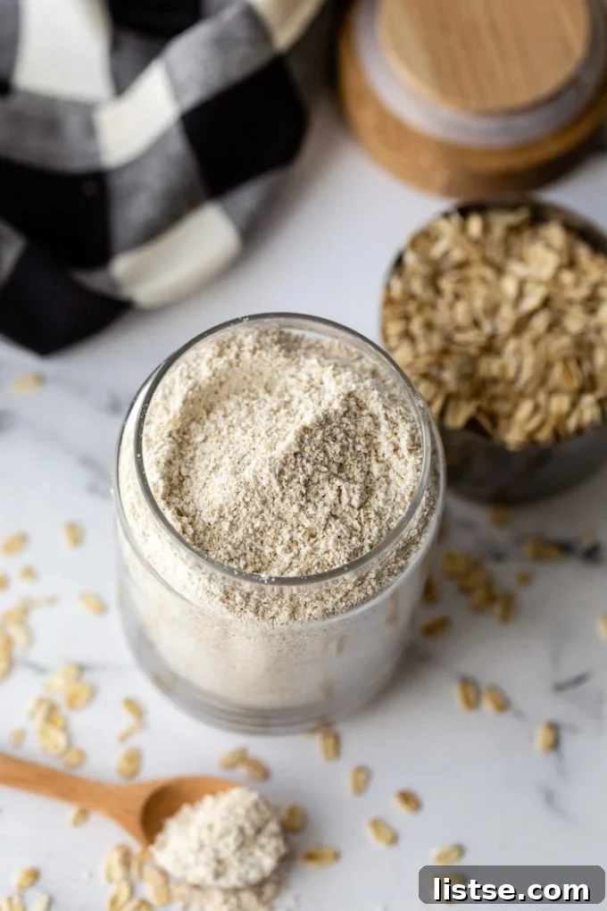 glass container filled with oat flour and fresh oats in the background