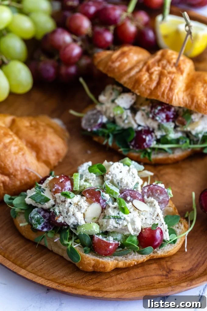 croissant cut in half and topped with micro green and the tofu "chicken" salad with grapes