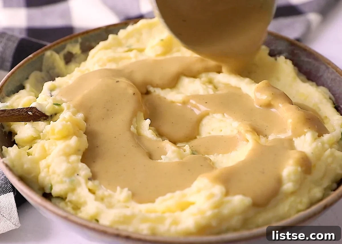 Effortless Vegan Gravy 8 vegan gravy being poured on to mashed potatoes