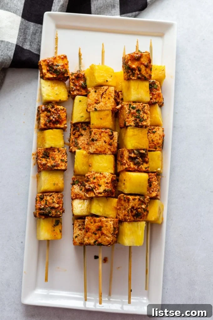 grilled skewers with tofu and pineapple on a white plate