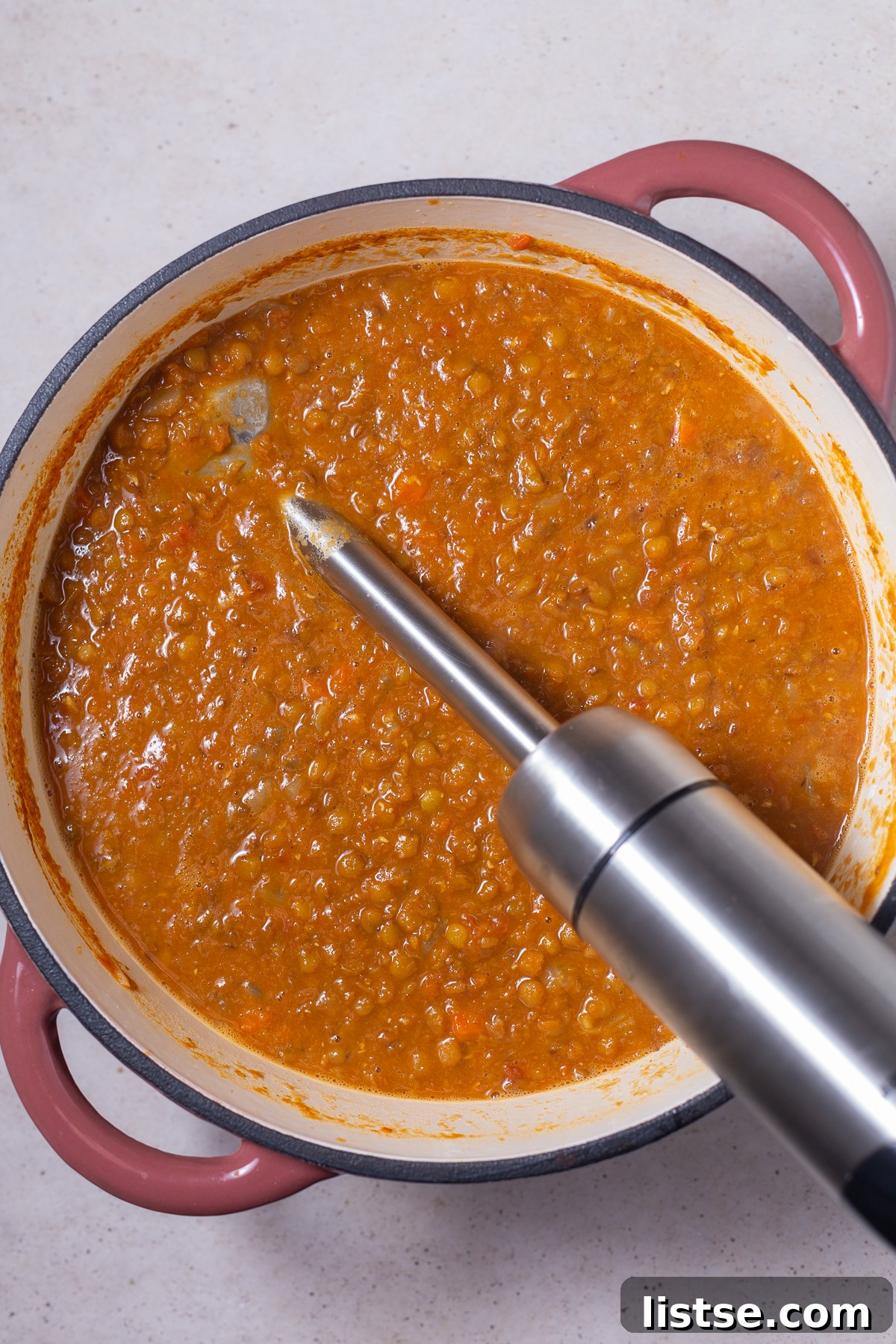 One-Pot Vegan Lentil Soup 8 vegan lentil soup. ina pot with an immersion blender hanging out the side