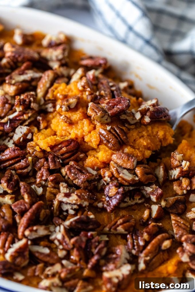 Wholesome Vegan Sweet Potato Bake 6 a fresh pan of vegan sweet potato casserole with candied pecans being removed from the oven