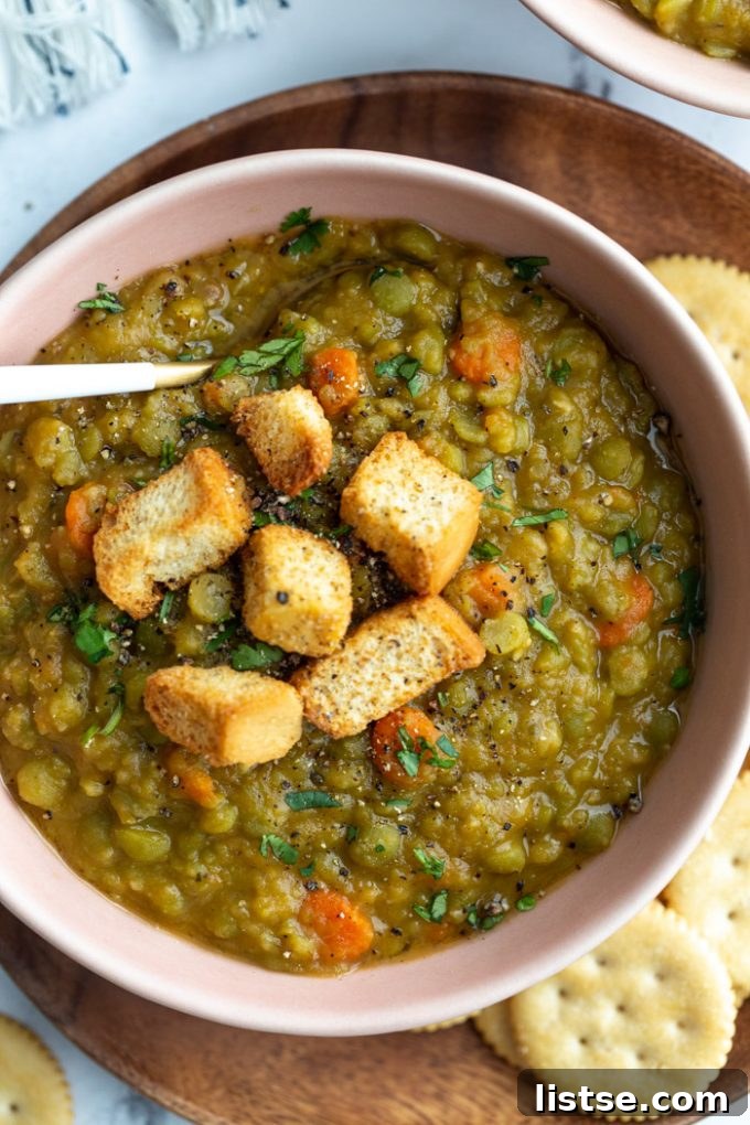 Vegan split pea soup generously topped with crispy croutons for added texture.