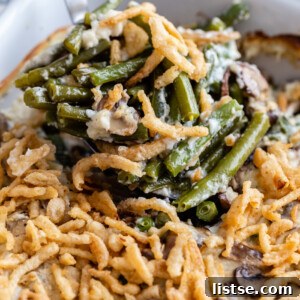 up close shot of green bean casserole in a baking dish and covered with crispy onions