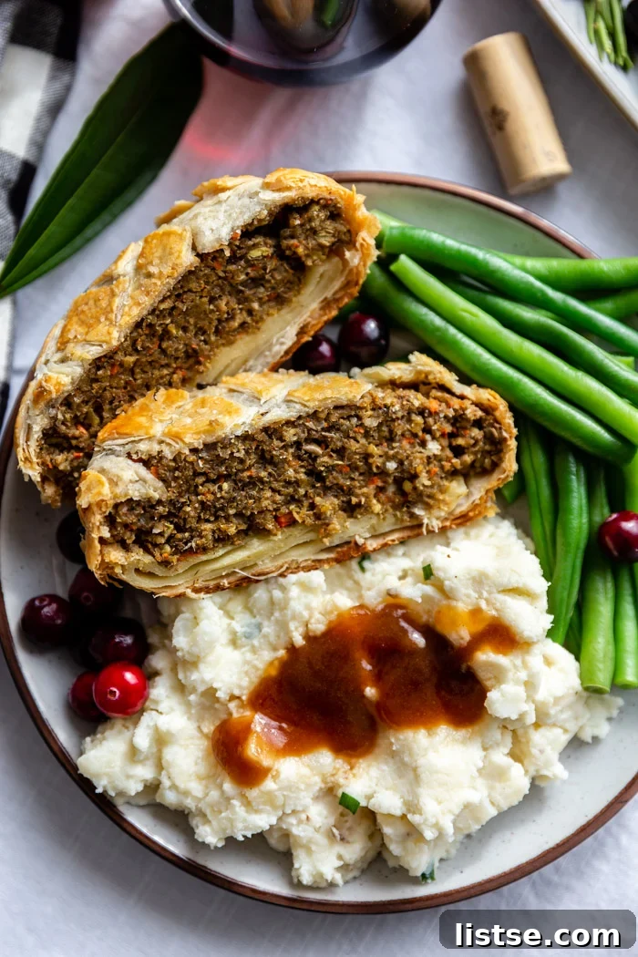 plate filled with vegetarian wellington, green beans and mashed potatoes and gravy