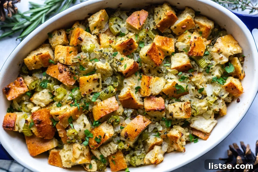 Foolproof Vegan Holiday Stuffing 2 Deliciously crispy and soft vegan stuffing in a casserole dish, adorned with fresh herbs, ready to be served at a festive holiday meal.
