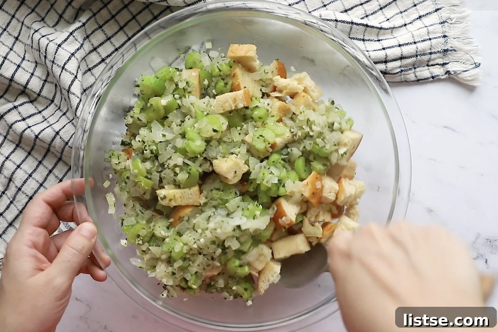 Foolproof Vegan Holiday Stuffing 7 Fragrant sautéed onions, celery, and herbs, mixed with perfectly toasted bread cubes in a spacious bowl, awaiting the liquid ingredients for vegan stuffing.