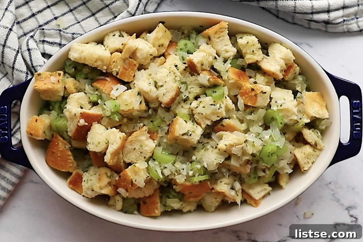 Foolproof Vegan Holiday Stuffing 8 Prepared vegan stuffing mixture, spread evenly in a baking dish and garnished with fresh sage, ready to be baked to golden, aromatic perfection.