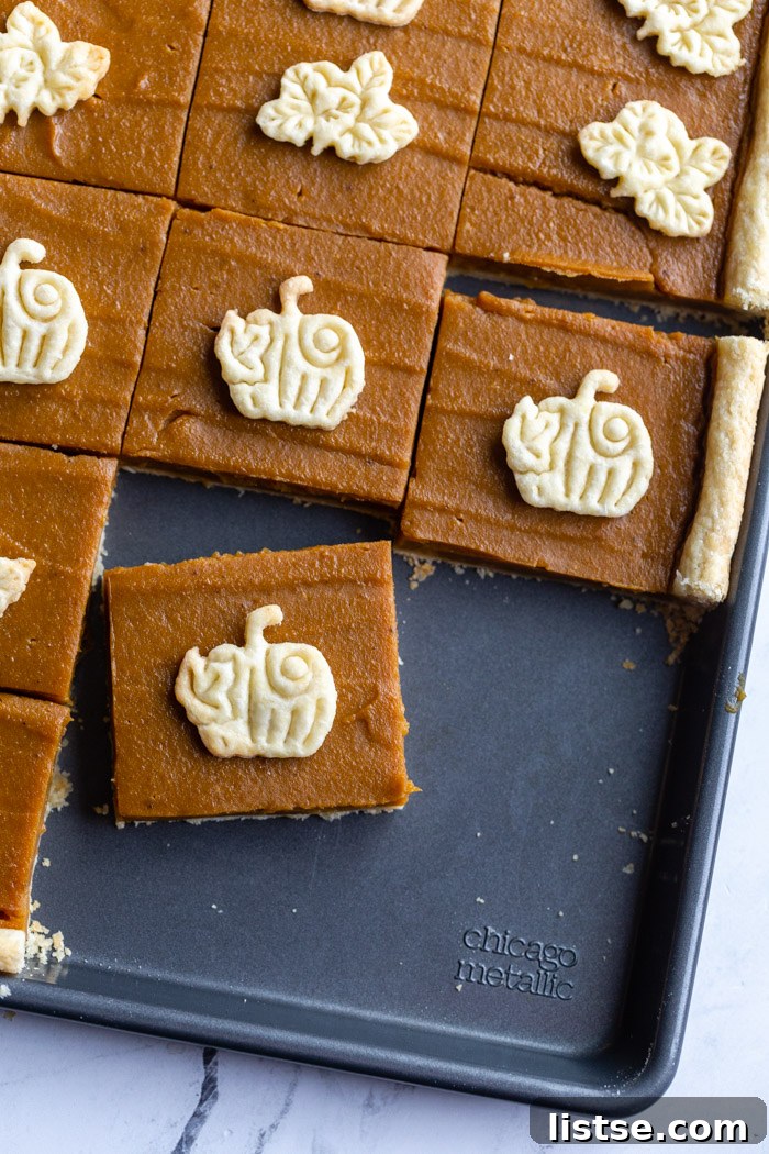 Pumpkin Slab Pie 5 square sliced of pumpkin pie on a sheet pan each topped with a crust cutout pumpkin