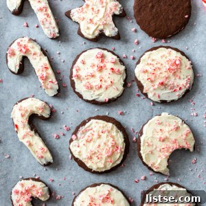 sheet pan filled with chocolate cut out cookies and tppped with a vanilla frosting and crushed peppermint