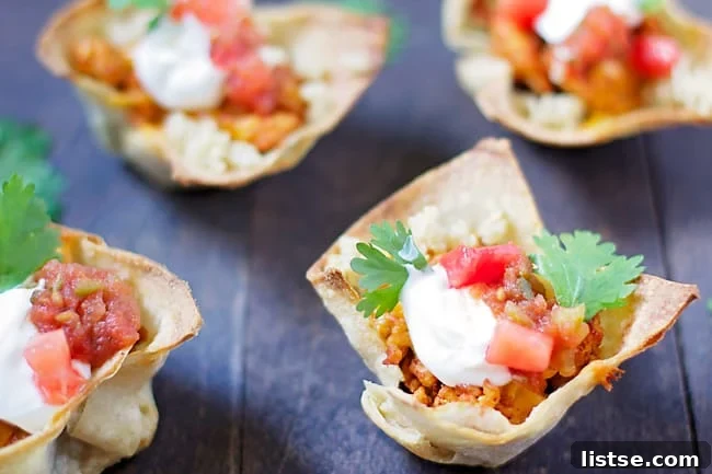 Three Taco Salad Cupcakes on a rustic wooden board