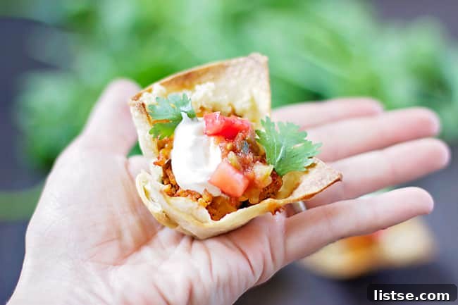 Taco Salad Cupcakes topped with sour cream, salsa, and cilantro