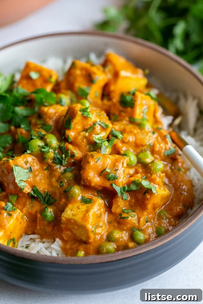 A generous serving of Tofu Tikka Masala in a large bowl, beautifully garnished with fresh cilantro leaves