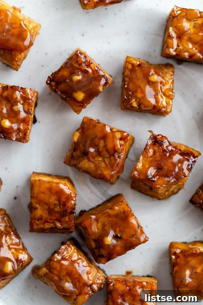 close up shot of baked tempeh covered in a teriyaki sauce