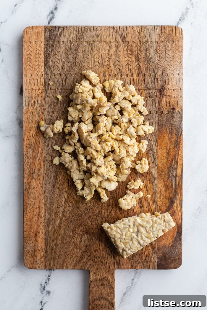 crumbled tempeh lying on a wood cutting board