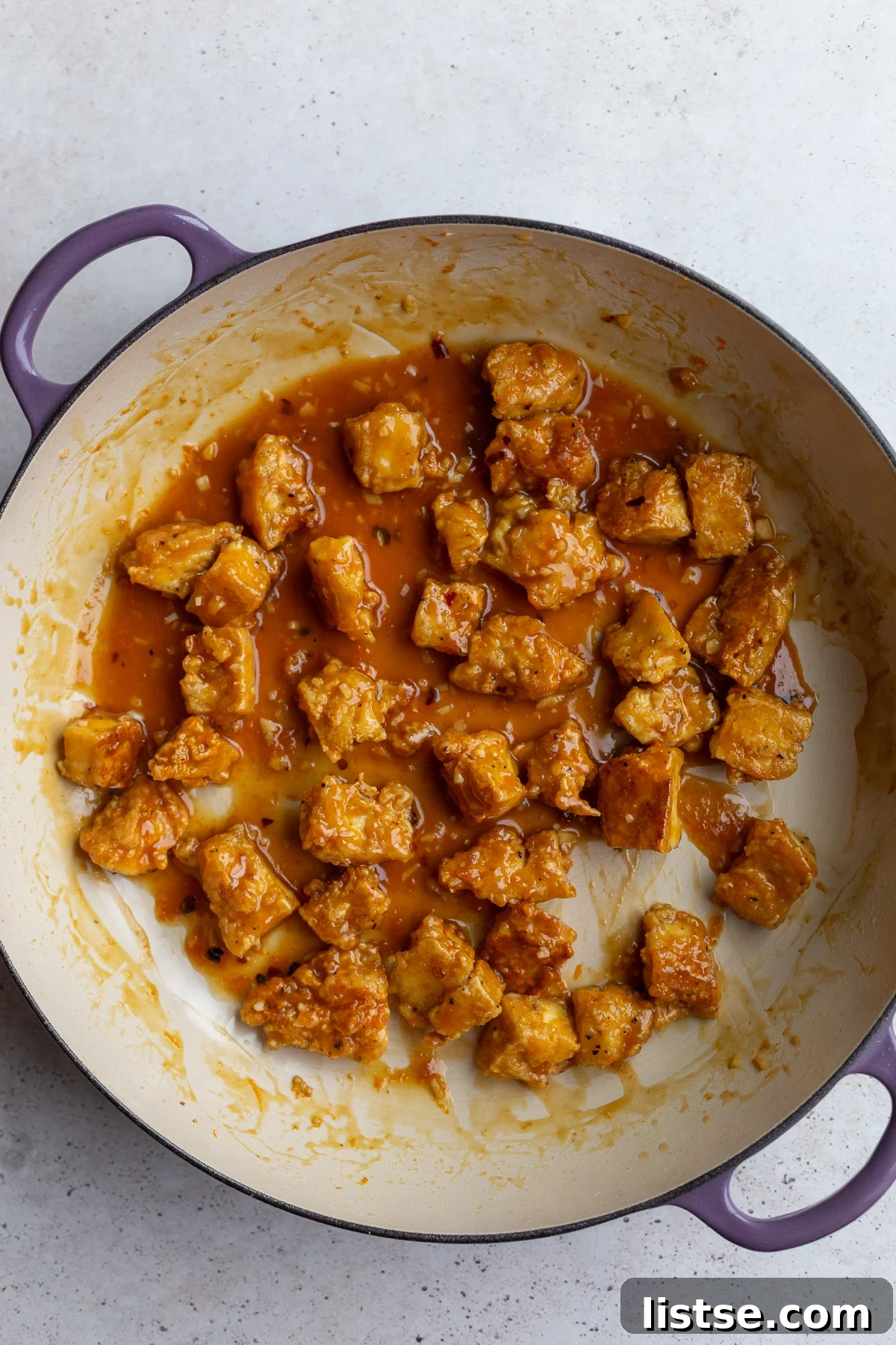 Crispy orange tofu tossed in the glossy sauce, ready to be served.