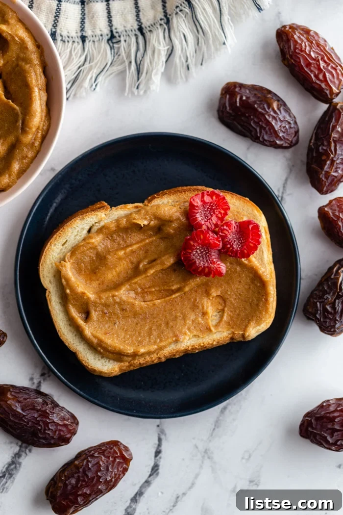 Natural Date Sweetener 6 A piece of toasted bread generously smeared with creamy date paste, topped with fresh red raspberries.