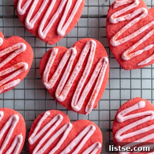 Artfully frosted vegan heart cookies with a lovely pink zig-zag design, ideal for a romantic Valentine's treat.