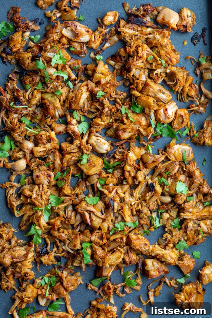 Pulled Jackfruit Carnitas 4 shredded jackfruit carnitas on a baking tray and topped with cilantro