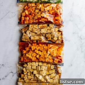 6 gallon baggies filled with tofu cubes and varies flavors and colors of tofu marinade