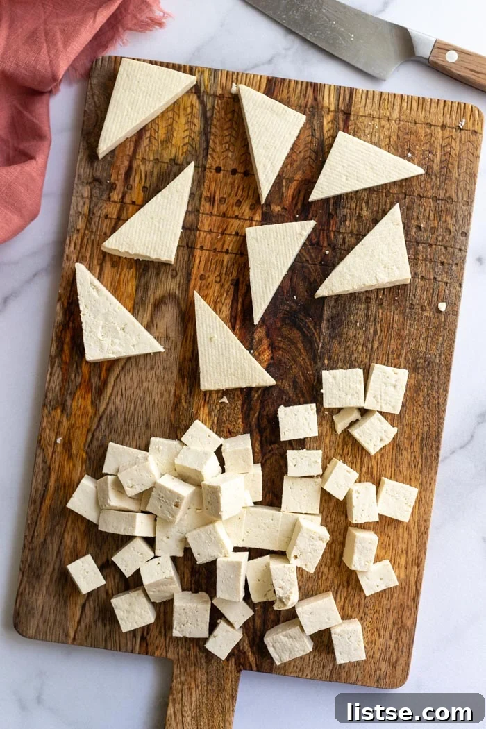 6 Effortless Tofu Marinade Ideas 5 tofu on a cutting board with some cut into triangles and some is cut inot cubes