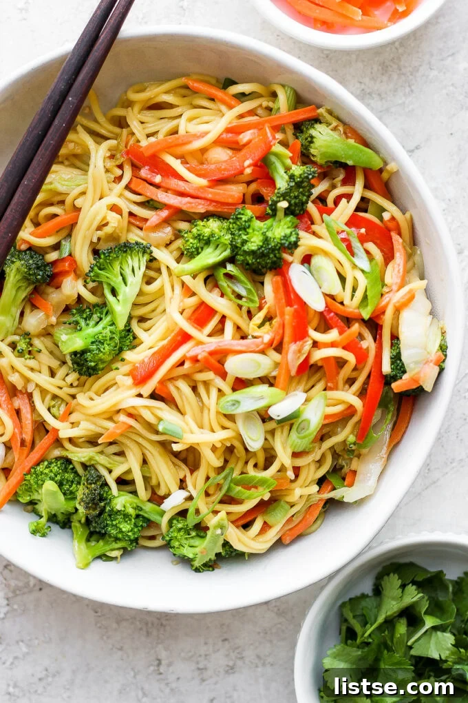 Large bowl of homemade vegetable chow mein, showcasing tender noodles and colorful stir-fried vegetables.