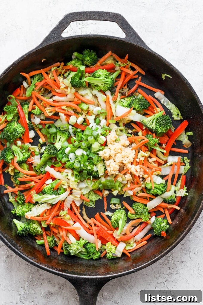 Freshly sliced cabbage and green onions, essential ingredients for vegetable chow mein.